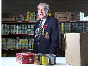 Joey Bleviss, CEO of the Poppy Fund, helps pack some of the food hampers destined for needy veterans in their Calgary warehouse in this file photo.