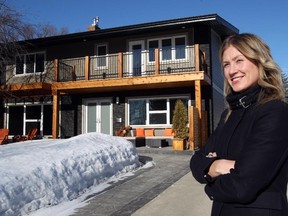 File — Calgary realtor Tamara Pilipchuk, with RE/MAX Realty Professionals, outside a home in North Glenmore  listed in January, 2014