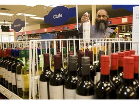 Paul Dhillon of Stampede Liquor Co. tends to his inventory.