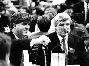 In this  June 16, 1990 file photo, Vancouver Canucks coach Pat Quinn (smoking cigar on the right) is seen with Brian Burke. The latter, now the Flames' president of hockey operations, recounted his longtime friendship with the late hockey guru during an emotion press conference on Wednesday.