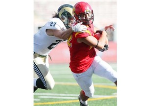 Regina Rams defender Joey Dwyer tries to bring down Dinos receiver Kyle Brick during their Oct. 4 meeting. Calgary won that match 59-7 but will still need to be on its toes against Regina in Saturday’s Canada West semifinal.