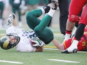 Regina Rams Mitch Thompson is tackled by Calgary Dinos  during the Canada West semifinal playoff game at McMahon Stadium  in Calgary on Saturday.