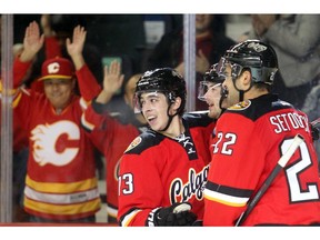 CALGARY, AB.; OCTOBER 31, 2014  --  Calgary Flames fan favourite Johnny Gaudreau celebrates his third period goal against the Nashville Predators with linemates Devin Setoguchi and Paul Byron at the Saddledome Friday October 31, 2014. (Ted Rhodes/Calgary Herald) For Sports story by Kristen Odland