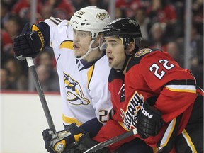 Devin Setoguchi of the Calgary Flames is tied up in front of the Nashville Predators net by Anton Volchenkov at the Saddledome Friday October 31, 2014.