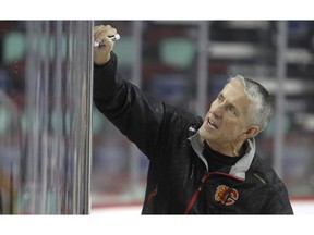Calgary  Flames coach Bob Hartley goes over the x's and o's.