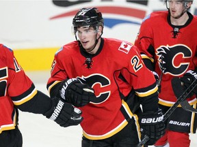 Sean Monahan of the Calgary Flames skates to the bench after scoring his second goal of the game against the Winnipeg Jets during the third period at the Saddledome  October 2, 2014.