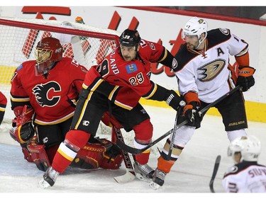 Colleen De Neve/ Calgary Herald CALGARY, AB --NOVEMBER 18, 2014 -- Calgary Flames defenceman Deryk Engelland worked to keep Anaheim Ducks centre Ryan Kesler at bay outside the net of goalie Jonas Hiller during second period NHL action at the Scotiabank Saddledome on November 18, 2014. (Colleen De Neve/Calgary Herald) (For Sports story by Scott Cruickshank) 00056694A  SLUG: 1119-Flames Ducks