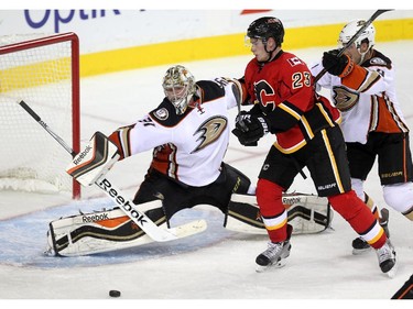 Colleen De Neve/ Calgary Herald CALGARY, AB --NOVEMBER 18, 2014 -- Calgary Flames centre Sean Monahan kept his eye on the puck outside the net of Anaheim Ducks goalie Frederik Andersen during the overtime period NHL action at the Scotiabank Saddledome on November 18, 2014. The Flames defeated the Anaheim Ducks 4-3 in overtime. (Colleen De Neve/Calgary Herald) (For Sports story by Scott Cruickshank) 00056694A  SLUG: 1119-Flames Ducks