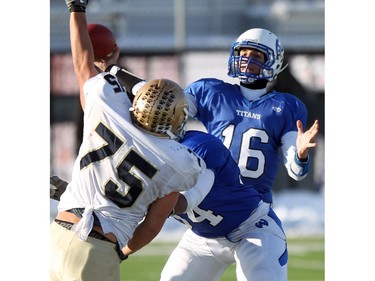 Titans quarterback Cody Olson tries to get a pass past Pride defensive lineman Sidney Valenzuela  as the Notre Dame Pride played host to the Harry Ainlay Titans in Tier I Provincial semifinal action on November 15, 21014. The Pride won 34 to 14.
