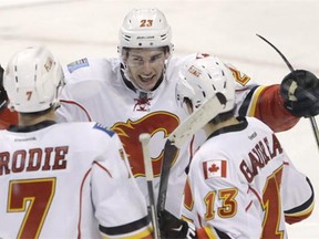 Calgary Flames centre Sean Monahan (23) celebrates with defenseman T.J. Brodie (7) and left wing Johnny Gaudreau (13) after Monahan scored a goal during the third period of an NHL hockey game against the Florida Panthers, Saturday, Nov. 8, 2014 in Sunrise, Fla.