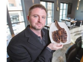 Stephen Deere, owner and manager or Modern Steak, poses for a photo in his restaurant with the 48 oz four week Dry Aged Tomahawk Chop for 2 menu item in Calgary, on October 24, 2014. -- 
 (Crystal Schick/Calgary Herald) (For Swerve story by   John Gilchrist) 
 00059805A