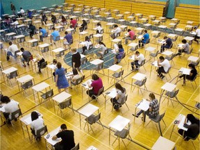 Students at Bishop McNally High School  write their biology 30 final exam in the school's gymnasium in this file photo.