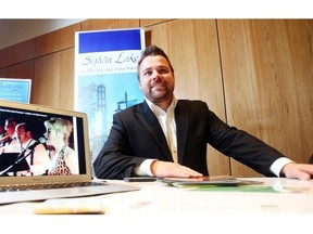 Sylvan Lake mayor Sean McIntyre stands alongside a promotional poster at the town’s booth in the Tourism and Investment Forum held Wednesday, November 5, 2014 at the Telus Convention Centre.