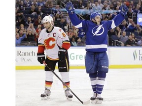 Tampa Bay Lightning centre Cedric Paquette celebrates one of his two goals in front of Calgary Flames defenceman Mark Giordano during the second period on Thursday. The Bolts won 5-2.