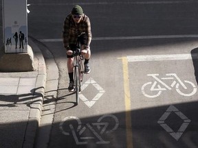 A cyclist pedals on the 7th Street SW dedicated bike lanes