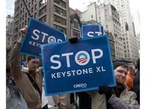 This May 13, 2013 file photo shows environmental activists as they protest proposed Keystone XL pipeline, in New York.