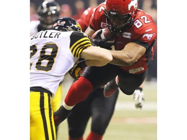 Gavin Young, Calgary Herald VANCOUVER, BC: NOVEMBER 30, 2014 - Calgary Stampeders Nik Lewis goes up and through the Hamilton Tiger Cats near the end zone in the 2014 Grey Cup in Vancouver on Sunday November 30, 2014. (Gavin Young/Calgary Herald) (For Sports section story by Rita Mingo, George Johnson) Trax# 00060714F
