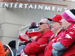 Stamps fans watch the 2014 Grey Cup parade in Vancouver on Saturday November 29, 2014.