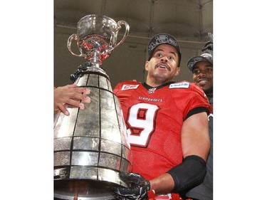 Gavin Young, Calgary Herald VANCOUVER, BC: NOVEMBER 30, 2014 - The Calgary Stampeders Jon Cornish holds the Grey Cup after the team won the 2014 Grey Cup in Vancouver on Sunday November 30, 2014. (Gavin Young/Calgary Herald) (For Sports section story by Rita Mingo, George Johnson) Trax# 00060714F