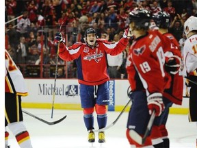Washington Capitals left winger Alex Ovechkin, left, celebrates a goal by teammate Nicklas Backstrom during the first period against the Calgary Flames on Tuesday. The helper made him the Capitals’ all-time franchise points leader.