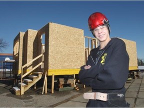 Wood frame construction course student Trueman Hughes, 16, in front of a project put together by students of Jack James High School and representatives from Homes by Avi. Trueman hopes to have a career in home construction.
