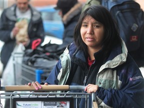 ennifer Gallup waits with her collection at the Uptown Bottle Depot, along with a lineup of other bottle pickers. She said she is currently staying at the Calgary Drop-In Centre.