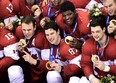 Team Canada captain Sidney Crosby, centre, poses for their team photo after defeating Sweden during third period finals hockey action at the 2014 Sochi Winter Olympics in Sochi, Russia on Sunday, February 23, 2014. THE CANADIAN PRESS/Nathan Denette