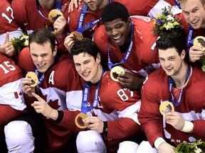 Team Canada captain Sidney Crosby, centre, poses for their team photo after defeating Sweden during third period finals hockey action at the 2014 Sochi Winter Olympics in Sochi, Russia on Sunday, February 23, 2014. THE CANADIAN PRESS/Nathan Denette