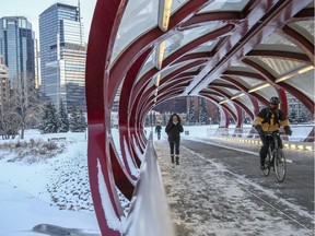 Ashley Sullivan crosses the Peace Bridge with other commuters after finishing a cold workday in downtown Calgary, on November 14, 2014.