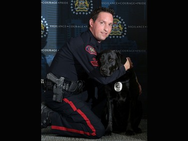 Calgary Police Victim Services four-year-old black Labrador retriever Hawk and his partner Sgt. Brent Hutt.