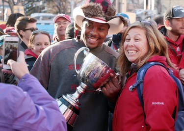 Red Deer's Michelle Skilmick posed for a photo with Nik Lewis and the Grey Cup following the Calgary Stampeders Grey Cup celebration rally at Calgary City Hall.