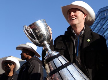 Calgary Stampeders quarterback Bo Levi Mitchell hoists the Grey Cup during the Grey Cup Champions rally at City Hall in Calgary.