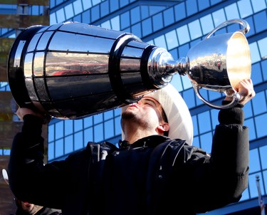 Calgary Stampeders kicker Rene Paredes hoists the Grey Cup during the Grey Cup Champions rally at City Hall in Calgary.