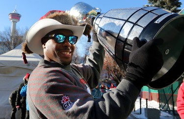 Calgary Stampeders Nik Lewis holds the grey Cup during the Grey Cup Champions rally at City Hall in Calgary.