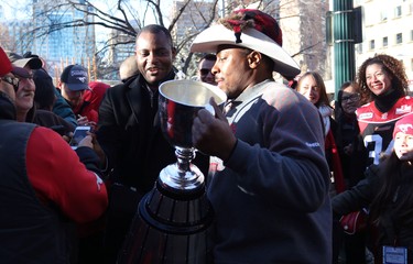 Calgary Stampeders Nik Lewis shows fans the grey Cup during the Grey Cup Champions rally at City Hall in Calgary.