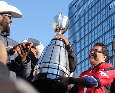Calgary mayor Naheed Nenshi holds the Grey Cup during the Grey Cup Champions rally at City Hall in Calgary.