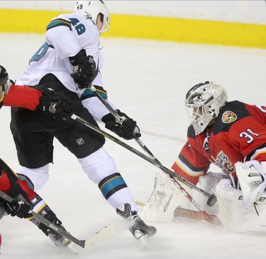Calgary Flames goalie Karri Ramo, right, blocks a goal by San Jose Sharks Tomas Hertl during their game at the Scotiabank Saddledome in Calgary on December 6, 2014.
(Leah Hennel/Calgary Herald)  
For Sports by Kristen Odland