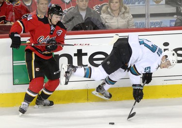 CALGARY;  DECEMBER 6, 2014  -- Calgary Flames Kris Russell, left and San Jose Sharks Tommy Wingels collide during their game at the Scotiabank Saddledome in Calgary on December 6, 2014.
(Leah Hennel/Calgary Herald)  
For Sports by Kristen Odland