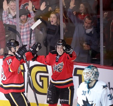 CALGARY;  DECEMBER 6, 2014  -- Calgary Flames Johnny Gaudreau, middle, celebrates a gaol on San Jose Sharks netminder Antti Niemi, right, with teammate Matt Stajan, left,  during their game at the Scotiabank Saddledome in Calgary on December 6, 2014.
(Leah Hennel/Calgary Herald)  
For Sports by Kristen Odland