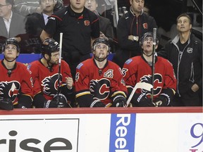 Calgary Flames defenceman Kris Russell, middle, checks out the replay board after his bobble getting the puck back to Karri Ramo led to a New York Ranger goal during the first period on Tuesday.
