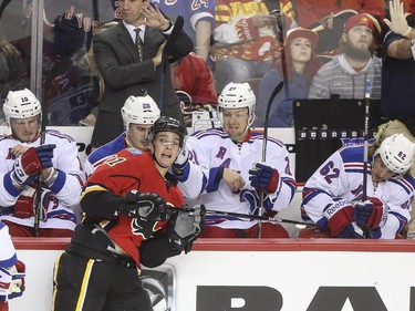 Do the New York Rangers all think that Calgary Flames Mason Raymond has the mumps? They all grimace as he nears their bench during first period action at the Scotiabank Saddledome in Calgary, on December 16, 2014.