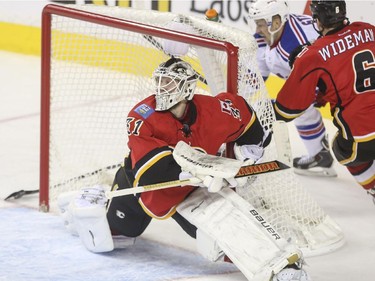 Calgary Flames goalie Karri Ramo stops a rap-around shot during second period action against the New York Rangers at the Scotiabank Saddledome in Calgary, on December 16, 2014.