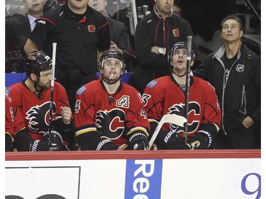 Calgary Flames Kris Russell checks out the replay board after accidentally helping score one for the New York Rangers during first period action at the Scotiabank Saddledome in Calgary, on December 16, 2014.