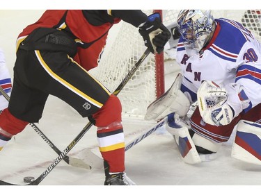 The Calgary Flames put the pressure on New York Rangers goalie Henrik Lundqvist during first period action at the Scotiabank Saddledome in Calgary, on December 16, 2014.