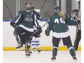 Saskatoon Stars' Sophie Shirley, left, celebrates scoring against the Edmonton Thunder during the Mac's AAA Midget Hockey Tournament in Calgary, on December 29, 2014. Saskatoon won the game 3-2.