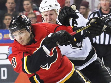 The Calgary Flames' Joe Colborne and the Los Angeles King's Matt Greene fight for position at the blue line during third period NHL action in Calgary. The Flames won 2-1.