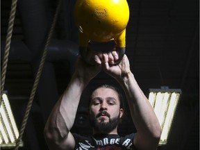 Damir Mulalic, contract personal trainer at 2110 Fitness, demonstrates how to swing a kettle ball.