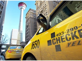 Taxis line up on 9th Avenue across from the Palliser Hotel as they wait for fares.