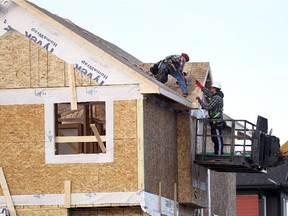 Construction workers worked on the roof of a home under construction in Evanston on December 8, 2014.