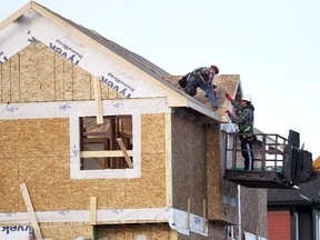 Construction workers worked on the roof of a home under construction in Evanston on December 8, 2014.